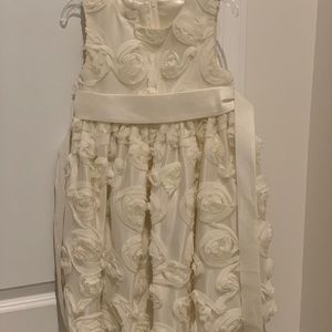 Beautiful cream dress with flower detail.
